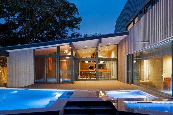A modern building with cedar siding and a pool
